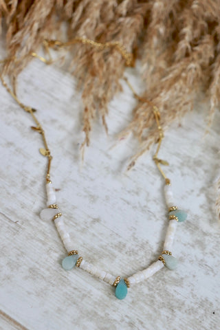 White bead necklace with blue tear drop bead